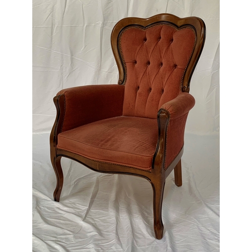 87 - STAINED OAK AND UPHOLSTERED ARMCHAIR
with a shaped button back above padded arms with a shaped seat ... 