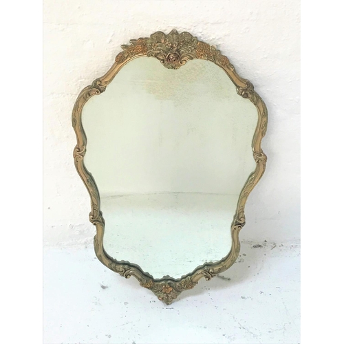 95 - SHAPED SILVERED FRAME WALL MIRROR
with floral decoration, 75.5cm high