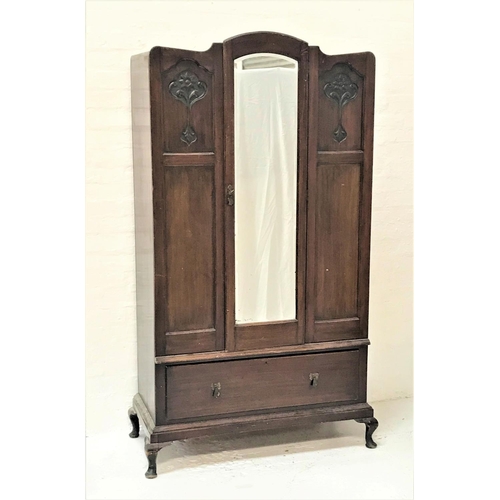 470 - MAHOGANY WARDROBE
with a shaped central door with a bevelled mirror flanked by carved floral panels ... 