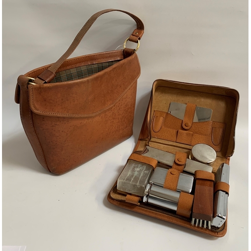 242 - NORRIS LADYS LEATHER HANDBAG
in tan with a short handle and side pocket, together with a tan leather... 