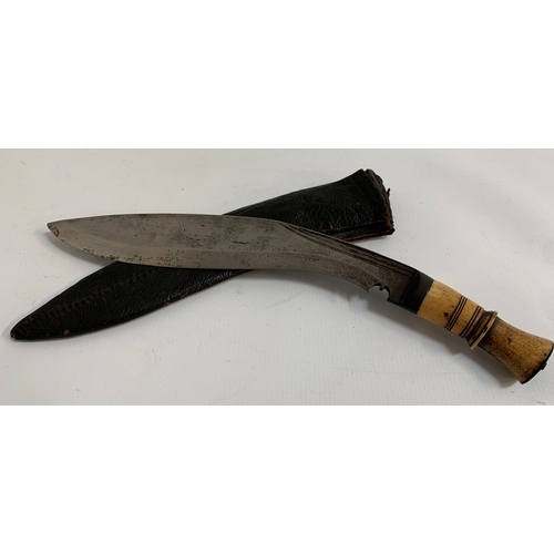 272 - KUKRI KNIFE
with a shaped blade and bone handle, contained in a leather sheath, 28.5cm long blade