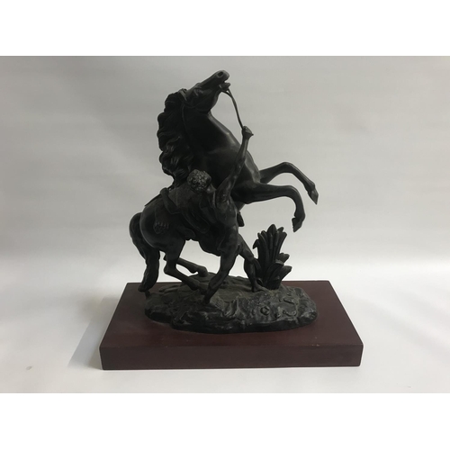 191 - SPELTER FIGURE ORNAMENT 
depicting a classical scene of rearing stallion with attendant, on mahogany... 