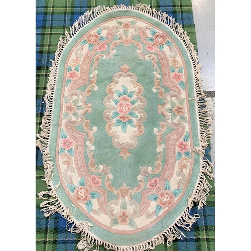 383 - OVAL CHINESE WASH RUG
the pale green ground with floral decoration, fringed, 157cm long excluding fr... 