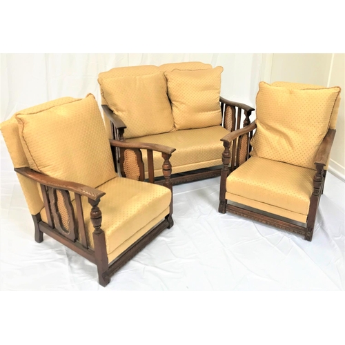 468 - 20TH CENTURY OAK SUITE
comprising a two seat sofa and two armchairs, all with shaped backs and outsw... 