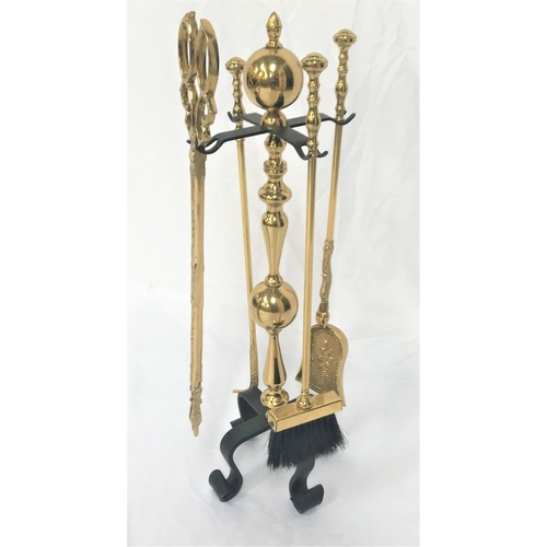 197 - DECORATIVE BRASS COMPANION SET
with a knopped stand raised on four iron scroll supports, with a shap... 