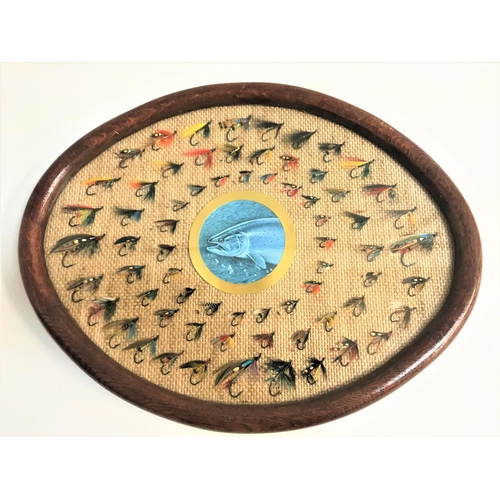 223 - EARLY 20TH CENTURY FISHING FLIES
the 67 flies mounted on hessian in an oval oak frame under glass, 4... 