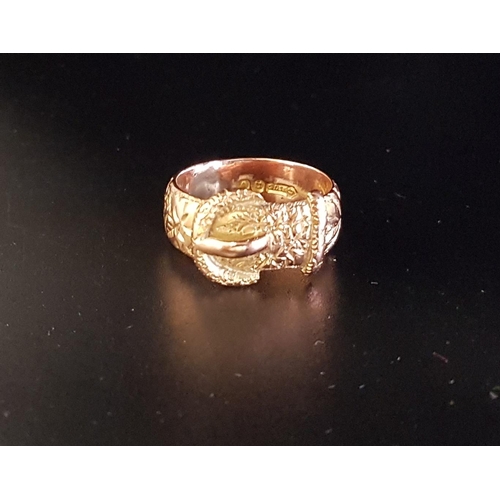 98 - NINE CARAT GOLD BUCKLE DESIGN RING
with engraved detail overall, ring size M-N and approximately 6.3... 