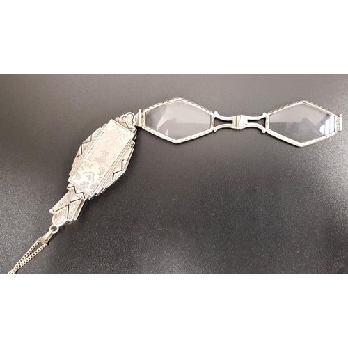 127 - UNUSUAL PAIR OF ART DECO SILVER LORGNETTES
the the spectacles folding into a shaped holder with geom... 