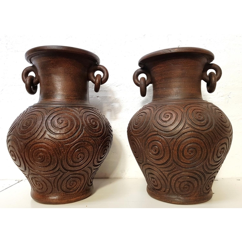 172 - PAIR OF POTTERY BALUSTER VASES
with a pair of articulated ring handles to the neck above a body with... 