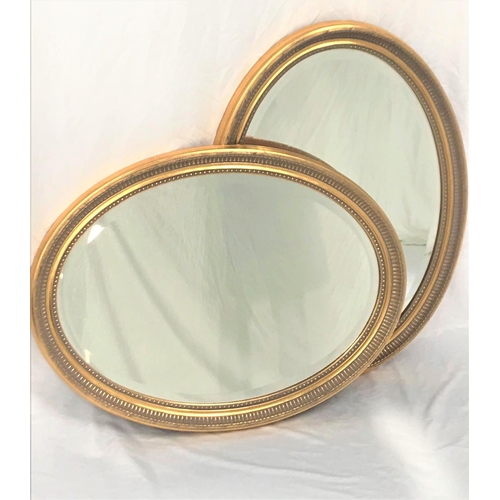 458 - PAIR OF OVAL GILTWOOD WALL MIRRORS
with bevelled plates, 79cm x 60cm (2)