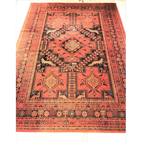 462 - LARGE MOSSOUL WOOL RUG
with a terracotta ground decorated with panels of animals and geometric motif... 