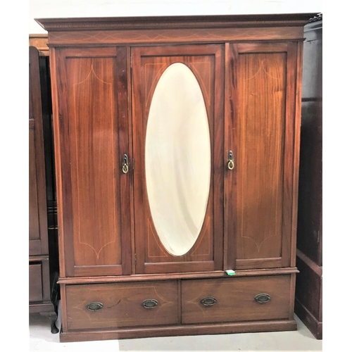 464 - EDWARDIAN MAHOGANY AND INLAID WARDROBE
with a moulded cornice above a central door with an oval mirr... 