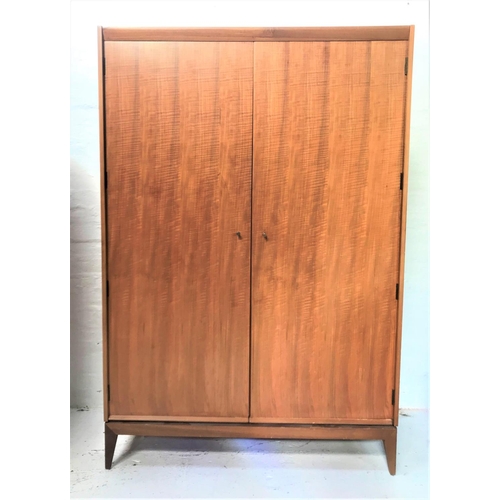 471 - A.YOUNGER LTD TEAK WARDROBE
with a plain top above two doors opening to reveal two hanging rails and... 