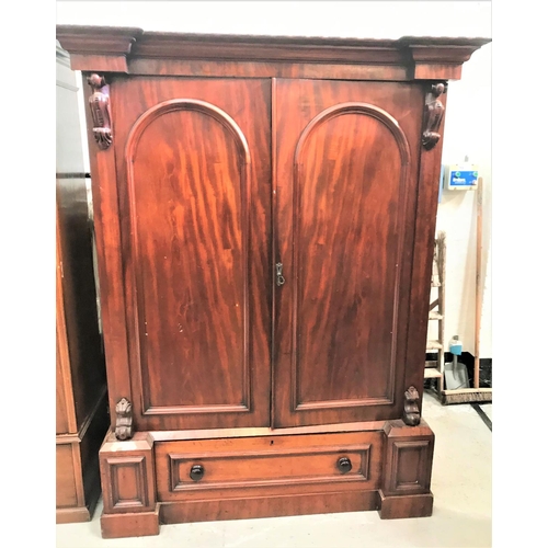 504 - VICTORIAN MAHOGANY WARDROBE
with an inverted breakfront moulded cornice above a pair of panelled arc... 