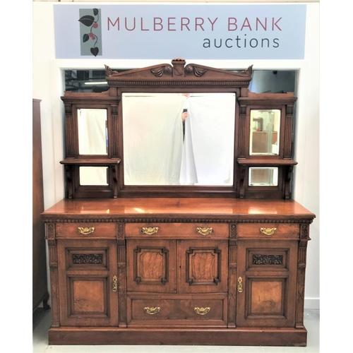 511 - IMPRESSIVE WALNUT MIRROR BACK SIDEBOARD
with a carved and shaped pediment centered with a shield abo... 