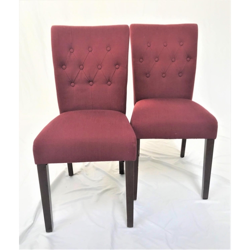 513 - SET OF TEN BUTTON BACK DINING CHAIRS
with padded backs and seats, covered in a raspberry coloured ma... 