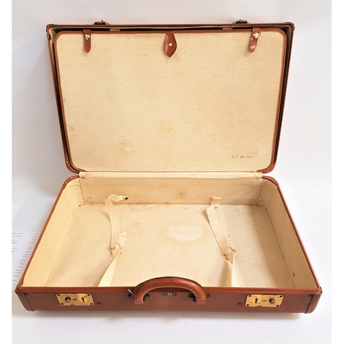 183 - VICTOR LEATHER SUITCASE
in tan with two brass locks, the interior with tie downs and and separate co... 