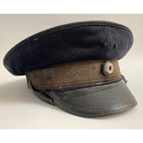 460 - WWII GERMAN NAZI PEAKED CAP
in blue cloth with a leather strap, marked to the clear plastic label wi... 