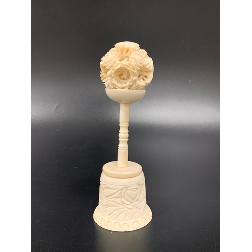 309 - CHINESE CARVED IVORY PUZZLE BALL
on a two piece carved and turned stand, 13.5cm high