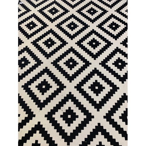 549 - LARGE BLACK AND WHITE RUG
with a geometric pattern, 300cm x 200cm