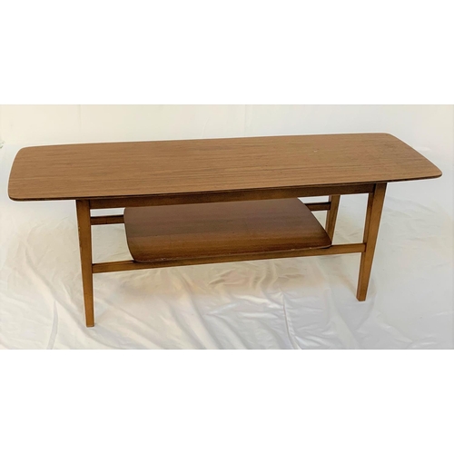 560 - TEAK OCCASIONAL TABLE
with an oblong top standing on turned supports united by an undertier, 121cm l... 