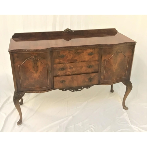 530 - FIGURED WALNUT SERPENTINE SIDEBOARD
with a shaped raised back above three central drawers flanked by... 