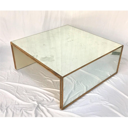 658 - CONTEMPORARY MIRRORED OCCASIONAL TABLE
with a mirrored top and side panel supports, with gilt burnis... 