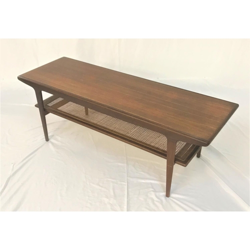 666 - TEAK OCCASIONAL TABLE
with an oblong top, standing on tapering supports united by an unusual caned u... 