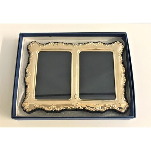 210 - SILVER DOUBLE PHOTOGRAPH FRAME
with embossed floral decoration to the shaped edges, on easel support... 