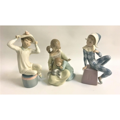 276 - THREE LLADRO FIGURINES
comprising the jester, 20cm high, two girls and a kitten, 17.5cm high and gir... 