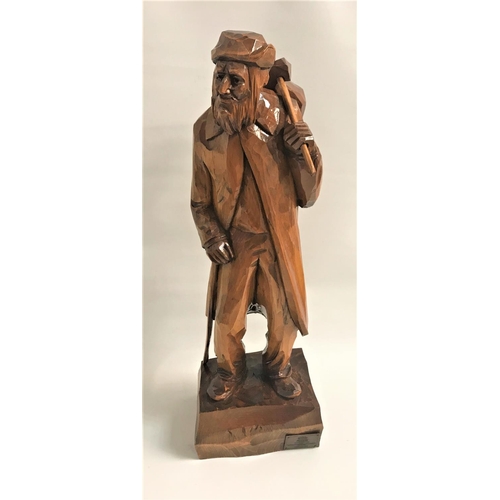 333 - CARVED TEAK FIGURE
depicting an old man with a walking stick and bindle over his shoulder, standing ... 