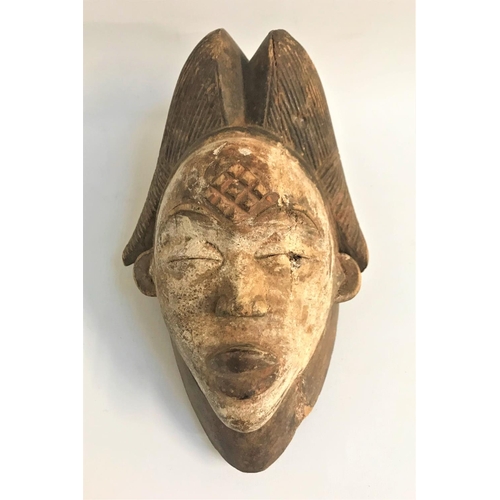 344 - GABON PUNU TRIBAL MASK
in carved wood with traces of white applied colour, with carved decoration to... 