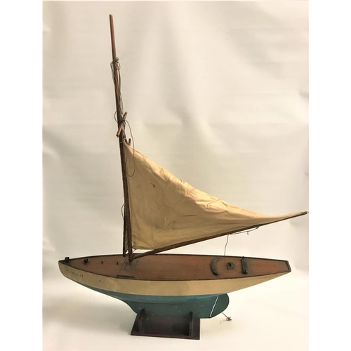 448 - VINTAGE POND YACHT
of wooden construction with two sails and a stand, 77cm long