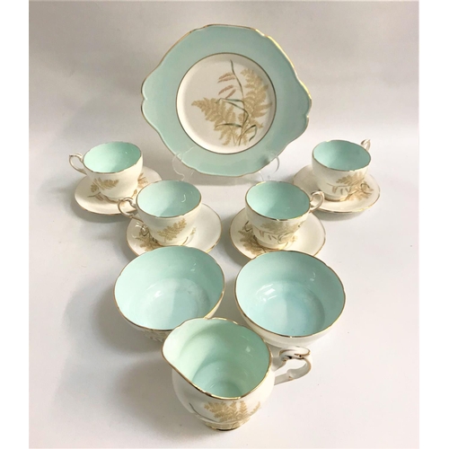 237 - PARAGON TEA SERVICE
decorated with ferns on a white ground with gilt highlights and a duck egg blue ... 