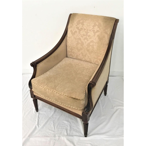 563 - MAHOGANY FRAME ARMCHAIR
with a padded back, sides and seat with a loose seat cushion, standing on tu... 