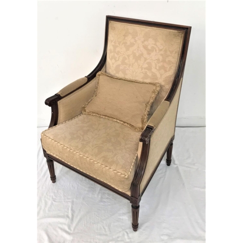 564 - MAHOGANY FRAME ARMCHAIR
with a padded back, sides, arms and seat with a loose seat cushion, standing... 