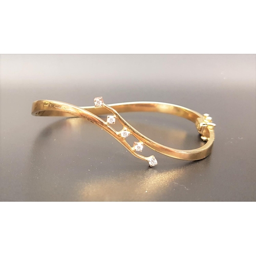 121 - ATTRACTIVE DIAMOND SET NINE CARAT GOLD BANGLE 
of twist design, the diamonds totaling approximately ... 