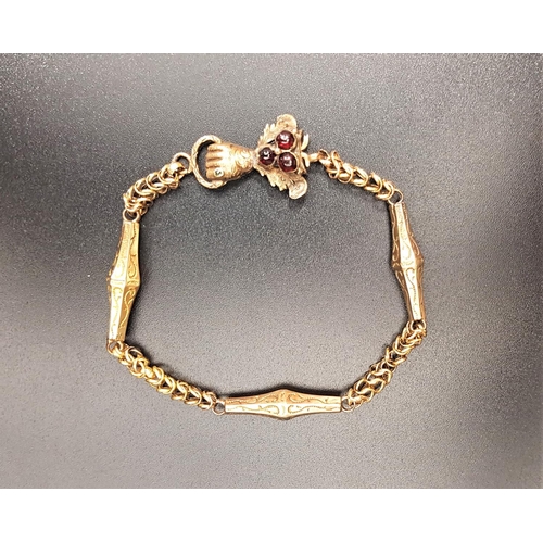 174 - VICTORIAN UNMARKED GOLD FANCY LINK BRACELET
the clasp with cabochon garnets and fist detail, total w... 