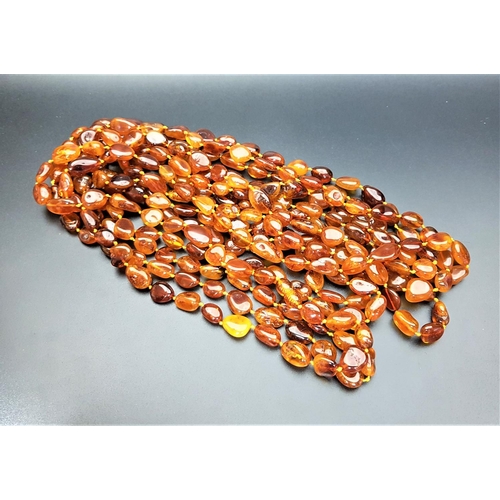 180 - LONG AMBER BEAD NECKLACE 
individually knotted, approximately 324cm long and 78 grams