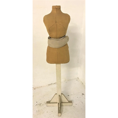 313 - FEMALE TORSO MANNEQUIN
with an adjustable horse hair waistband, on a painted wooden column with spla... 