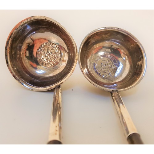 127 - TWO GEORGIAN SILVER TODDY LADLES
each with a cauldron shaped bowl centred with a flattened coin, bot... 