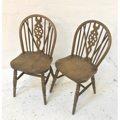 391 - PAIR OF ELM WHEEL BACK KITCHEN CHAIRS
with shaped backs and seats, standing on turned supports unite... 