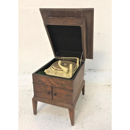 307 - MONARCH RECORD PLAYER
with three speed settings, contained in an oak case with a lift up lid and a p... 