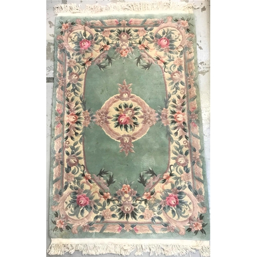 395 - CHINESE WASH RUG
the pale green ground with floral motifs, fringed, 192cm x 122cm excluding fringe