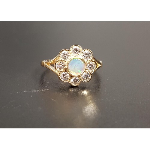 2 - PRETTY OPAL AND DIAMOND CLUSTER RING
the central round opal in eight diamond surround totaling appro... 
