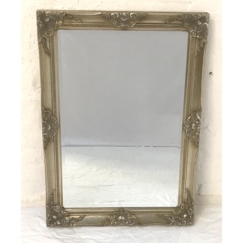 615 - RECTANGULAR WALL MIRROR
with decorative silvered frame and beveled plate, 63cm high