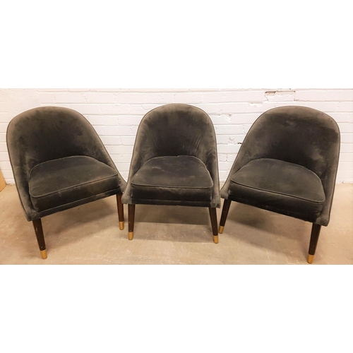 632 - THREE SLATE GREY VELVET COVERED CHAIRS
with shaped arched backs above padded seats, standing on tape... 