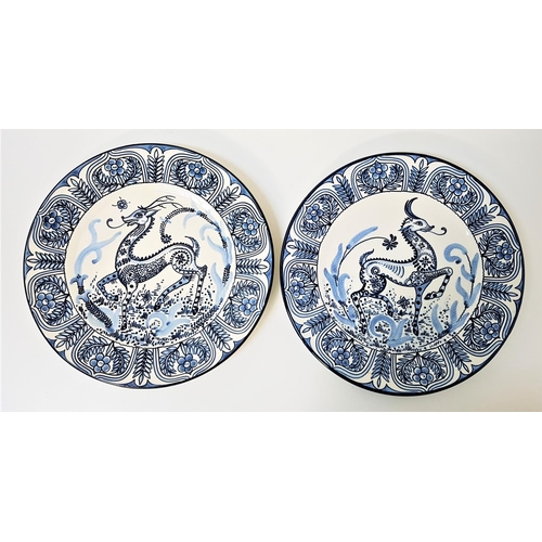 222 - PAIR OF CONTINENTAL POTTERY BLUE AND WHITE WALL CHARGERS
each decorated with a central deer and enca... 