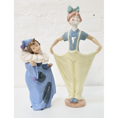 217 - TWO NAO FIGURINES 
comprising a young girl dressed like a clown with baggy trousers and a painted fa... 