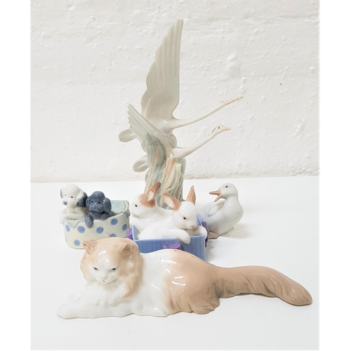 218 - FIVE NAO FIGURINES
comprising a pair of herons in flight, 27cm high; a relaxing cat, 25.5cm long; tw... 